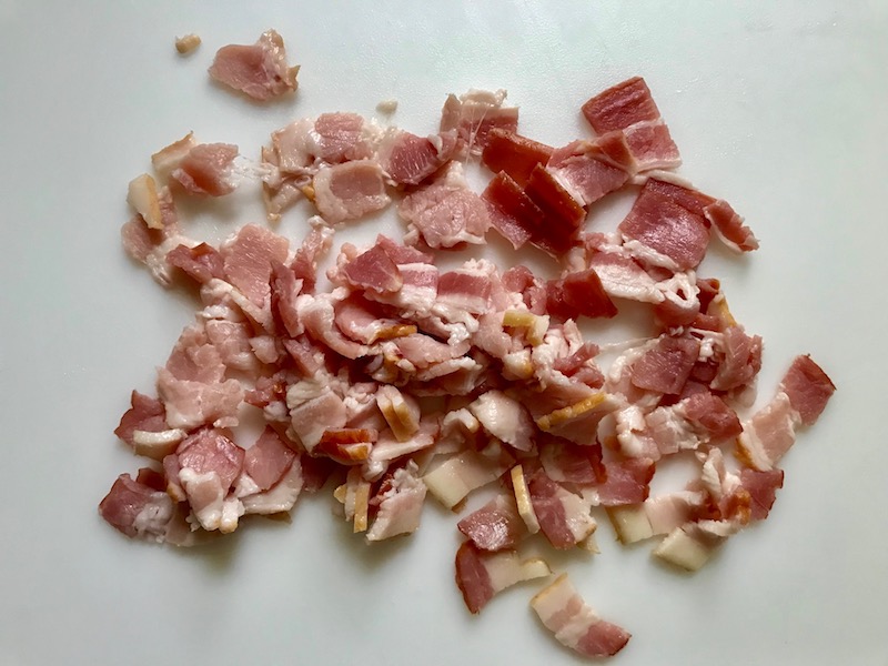 Cut raw bacon for Easy Bacon Brussel Sprouts and Chicken recipe. It's a perfect quick Fall Recipe! It has a creamy sauce filled with salty bacon, earthy and almost nutty seared brussel sprouts, and hearty healthy chicken. Serve over rice (or Quinoa or pasta!).