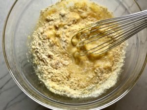 Ingredients in bowl for Cheddar Honey Cornbread piece in hand with more in background. It brings the salty and sweet combo to life spectacularly - particularly when the aromas from the honey, corn, and cheddar fill your house. This Gluten Free version is moist, slight salty from the cheese, slightly sweet from the honey and cornmeal. It's the perfect holiday meal side, whether it's breakfast, brunch, or dinner.