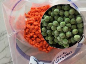 Peas and Carrots added to Freezer Bag for a 5-Ingredient Homemade Chicken Soup. It's thick, creamy, and hearty. It's filled with flavorful broth, meaty shredded chicken, and sweet bursts of bright veggies. You can prepare all of the ingredients ahead and freeze them until you are ready to cook. Then, thaw, pour into the Slow Cooker, set and forget.