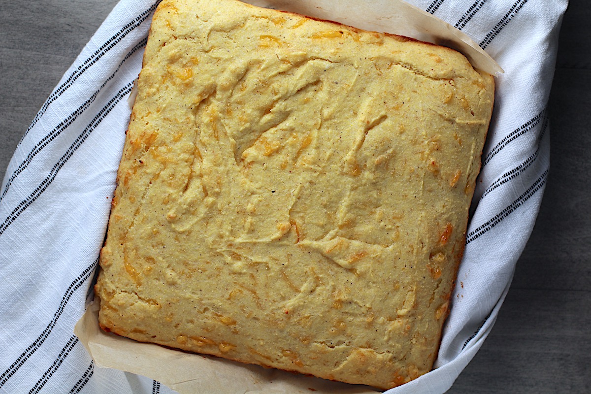 Cheddar Honey Gluten Free Cornbread still whole on kitchen towel.
