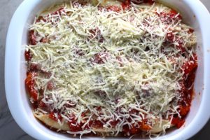 Mozzarella, Parmesan and Tomatoes on Stuffed Pasta Shells layered into a casserole dish for Turkey Ricotta Stuffed Shells in Tomato Sauce. These are the perfect way to repurpose and transform leftover Turkey or Chicken. The Shredded Turkey, Italian seasonings, mozzarella, and ricotta are stuffed in shells and topped with a simple tomato sauce and more melty mozzarella and nutty parmesan, it's a perfect dish that the family will love!