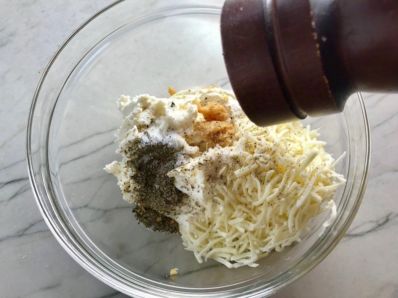 Ricotta Filling ingredients in a bowl for Turkey Ricotta Stuffed Shells in Tomato Sauce. They are the perfect way to repurpose and transform leftover Turkey or Chicken. The Shredded Turkey, Italian seasonings, mozzarella, and ricotta are stuffed in shells and topped with a simple tomato sauce and more melty mozzarella and nutty parmesan, it's a perfect dish that the family will love!