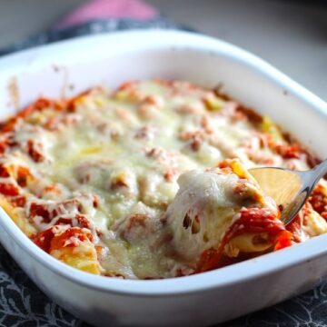 Turkey Ricotta Stuffed Shells in Tomato Sauce in casserole dish with piece scooped out. These are the perfect way to repurpose and transform leftover Turkey or Chicken. The Shredded Turkey, Italian seasonings, mozzarella, and ricotta are stuffed in shells and topped with a simple tomato sauce and more melty mozzarella and nutty parmesan, it's a perfect dish that the family will love!