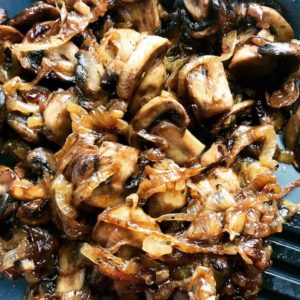 Close up of Caramelized Onions and mushroom slices in skillet for the Caramelized Onions & Mushrooms on Pork Tenderloin recipe. This is such a flavorful main dish! The pork tenderloin is moist and juicy and topped with Onions & Mushrooms that are sauteed low and slow with a touch of balsamic to bring out all of the natural sugars and caramelize them to perfection.