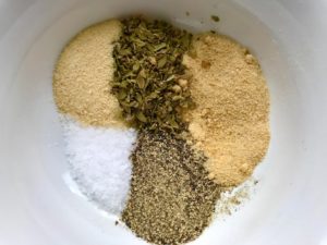 Dried Oregano, Garlic Salt, Pepper, Salt, & Onion Powder in bowl for the Caramelized Onions & Mushrooms on Pork Tenderloin recipe. This is such a flavorful main dish! The pork tenderloin is moist and juicy and topped with Onions & Mushrooms that are sauteed low and slow with a touch of balsamic to bring out all of the natural sugars and caramelize them to perfection.