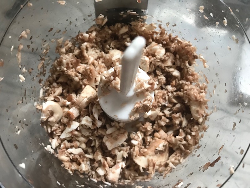 Mushrooms blended in food processor before cooking and turning into stuffing. This Stuffed Flank Steak recipe is oozing with flavor! First, you get mushrooms, onions, and garlic sauteed together. Then they are mixed with fresh parsley and basil, then parmesan, and goat cheese! Roll it all up in Flank Steak and roast for an amazing dinner.