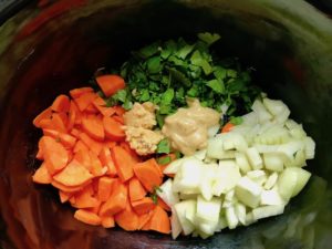 Carrots, onion, parsley, garlic, dijon in crockpot for the Slow Cooker Beef Stew over Noodles recipe. It's comfort food full of flavor and texture with carrots, onion, garlic, thyme, beef, and more. Now, try pouring that salty, chunky, saucy goodness over noodles...yup, even more amazing! #beefstew #crockpot #slowcooker #easydinners #dinnerrecipes