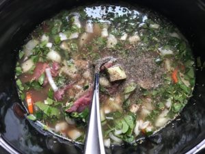 Beef, carrots, onion, broth, and other ingredients in crockpot for the Slow Cooker Beef Stew over Noodles recipe. It's comfort food full of flavor and texture with carrots, onion, garlic, thyme, beef, and more. Now, try pouring that salty, chunky, saucy goodness over noodles...yup, even more amazing! #beefstew #crockpot #slowcooker #easydinners #dinnerrecipes