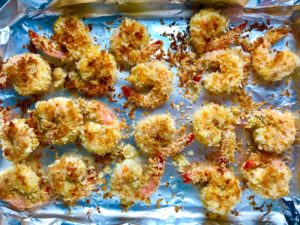 Baked Coconut Shrimp on pan. Crunchy and utterly irresistible, this 30-Minute Baked Coconut Shrimp recipe is one that you have got to try! They are baked, not fried, so they are EASY to cook and HEALTHIER for you too!