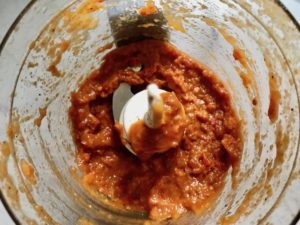 Ingredients blended in food processor for Sun Dried Tomato Chicken. It's slightly sweet, slightly tart and tangy, and hugely delicious! When Sun dried tomatoes are rehydrated and blended, they turn into a thick and lucious sauce that coats the chicken keeping it moist and juicy when it simply bakes in the oven. It's a perfect easy weeknight dinner that you can prepare ahead and cook quickly! #chicken #chickenrecipes #easydinners #dinnerrecipes