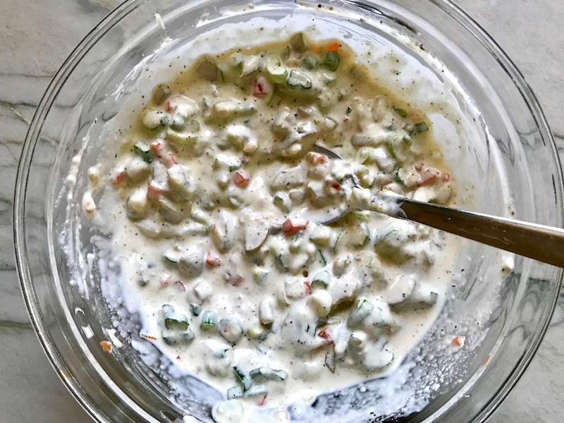 Chopped green olives and pimiento sauce in bowl for the Creamy Olive Chicken recipe. This is magnificently thick and creamy and infused with garlic flavor and nuttiness from the Parmesan. The best part; however, is the salty and briny flavor kick from the green olives with a little sweetness from the pimiento. #chicken #chickenrecipes #chickendinner #easydinners #easyrecipes #comfortfood #casserole