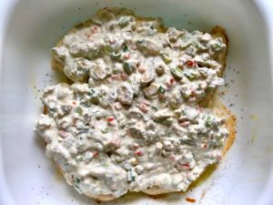 Sauce on Chicken in pan for the Creamy Olive Chicken recipe. This is magnificently thick and creamy and infused with garlic flavor and nuttiness from the Parmesan. The best part; however, is the salty and briny flavor kick from the green olives with a little sweetness from the pimiento. #chicken #chickenrecipes #chickendinner #easydinners #easyrecipes #comfortfood #casserole