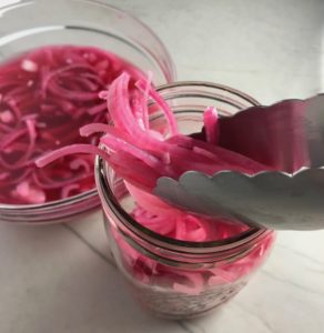 Pickled Onions for Slow Cooker Pork Tacos with with Pickled Onions, Shredded Cheese, and Cilantro Lime Crema drizzled on top! It's such an easy dinner since the pork cooks in the slow cooker to be perfectly seasoned and fall apart tender. #tacos #easydinner #glutenfree #dinner #mexican #pork