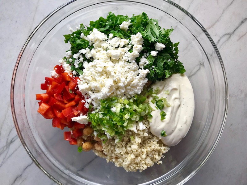 All ingredients in bowl for Quinoa & Kale Salad with Roasted Chickpeas, Pomegranate, Feta, red pepper, and Creamy Lemon Dressing. #glutenfree #lunch #dinner #healthyrecipes #healthyfood #salads #quinoa #kale