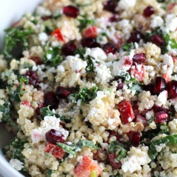 Close up of bowl of Quinoa & Kale Salad with Roasted Chickpeas, Pomegranate, Feta, red pepper, and Creamy Lemon Dressing. #glutenfree #lunch #dinner #healthyrecipes #healthyfood #salads #quinoa #kale