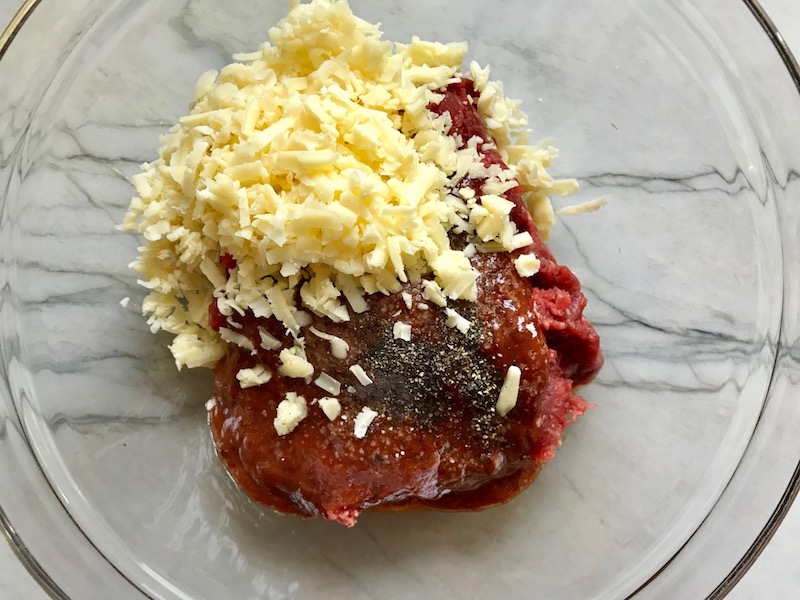 All ingredients in bowl with cheddar cheese and ground beef for Chipotle Meatloaf. It's incredibly easy, incredibly moist, and incredibly delicious! A family dinner favorite! #meatloaf #mexican #easydinner #familydinner #dinner #easyrecipes #beef