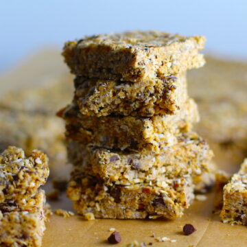 No Bake Energy Bites cut into squares and stacked. These Easy Nut-Free, No-Bake Energy Bites with Chocolate Chips are magnificent! They are sweet, chewy, crunchy, & healthy. Only minutes to make & no Baking! Breakfast, snack, or dessert. #energybars #granolabars #snackrecipes #healthyfood #healthyrecipes #healthysnacks #healthybreakfast #healthydessert