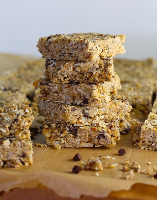 No Bake Energy Bites cut into squares and stacked. These Easy Nut-Free, No-Bake Energy Bites with Chocolate Chips are magnificent! They are sweet, chewy, crunchy, & healthy. Only minutes to make & no Baking! Breakfast, snack, or dessert. #energybars #granolabars #snackrecipes #healthyfood #healthyrecipes #healthysnacks #healthybreakfast #healthydessert