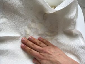 Hand pressing on paper towel over tofu pieces for Roasted Tofu Croutons. These are seasoned and toasted for the perfect addition to any salad, pasta, rice, or soup! They get a roasted, almost nutty flavor with a salty and smoky seasoned crust with a chewy bite. Super easy to make, low carb and great source of protein! #croutons #salad #tofu #tofurecipes #vegetarian #plantbased #paleo