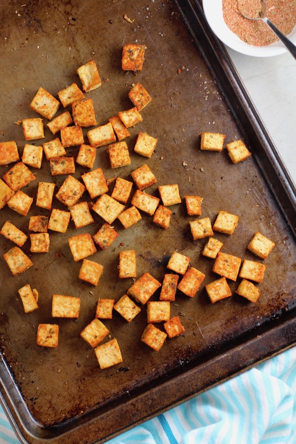 Roasted Tofu Croutons on pan. These are seasoned and toasted for the perfect addition to any salad, pasta, rice, or soup! They get a roasted, almost nutty flavor with a salty and smoky seasoned crust with a chewy bite. Super easy to make, low carb and great source of protein! #croutons #salad #tofu #tofurecipes #vegetarian #plantbased #paleo