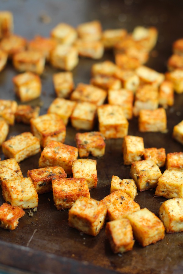 Savory Baked Tofu Bites on pan. These are seasoned and toasted for the perfect addition to any salad, pasta, rice, or soup! They get a roasted, almost nutty flavor with a salty and smoky seasoned crust with a chewy bite. Super easy to make, low carb and great source of protein! #croutons #salad #tofu #tofurecipes #vegetarian #plantbased #paleo