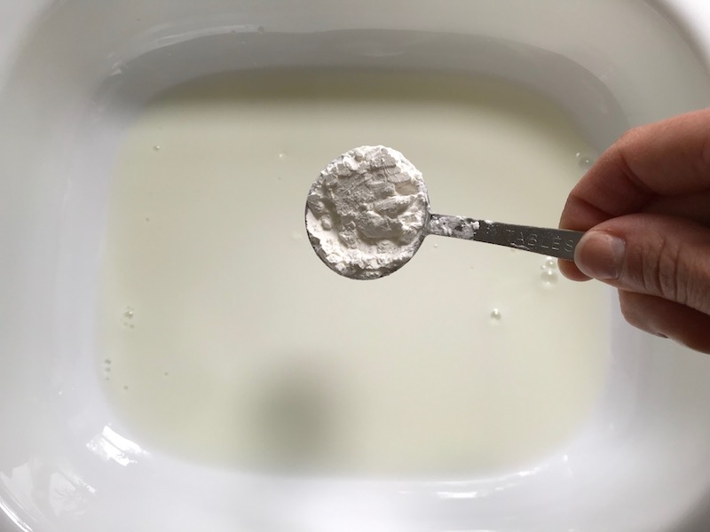 Adding cornstarch to milk for Cauliflower Cheese and Ham recipe. It layers in nutty and salty Gruyere Cheese, with a creamy Vegetable broth based sauce with garlic and parsley. Then the ham and cauliflower are folded into all of this goodness and it's baked in the oven until it all becomes one knock-your-socks-off dish! #cauliflower #lowcarb #glutenfree #casserole #onepot #familydinner #mealprep #easydinner #dinner #healthydinner #healthyfood #healthyrecipes