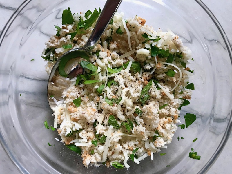 Breadcrumbs, cheese, and parsley topping in bowl for Cauliflower Cordon Bleu Bake recipe. It layers in nutty and salty Gruyere Cheese, with a creamy Vegetable broth based sauce with garlic and parsley. Then the ham and cauliflower are folded into all of this goodness and it's baked in the oven until it all becomes one knock-your-socks-off dish! #cauliflower #lowcarb #glutenfree #casserole #onepot #familydinner #mealprep #easydinner #dinner #healthydinner #healthyfood #healthyrecipes