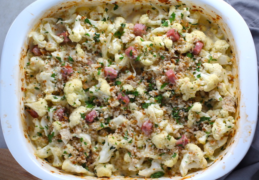 Cauliflower Cordon Bleu Bake with parsley and breadcrumb topping. It layers in nutty and salty Gruyere Cheese, with a creamy Vegetable broth based sauce with garlic and parsley. Then the ham and cauliflower are folded into all of this goodness and it's baked in the oven until it all becomes one knock-your-socks-off dish! #cauliflower #lowcarb #glutenfree #casserole #onepot #familydinner #mealprep #easydinner #dinner #healthydinner #healthyfood #healthyrecipes