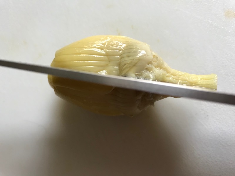 Cutting artichoke hearts for Artichoke Spinach Stuffed Zucchini Recipe. Each fantastic bite gives you creamy artichoke, nutty cheesy Parmesan, spinach, and zucchini. Prepare entirely ahead, then bake 20 minutes and enjoy! #vegetarian #zucchini #stuffedzuchini #spinach #artichoke #springrecipes #healthyfood #healthydinner #healthyrecipes #glutenfree