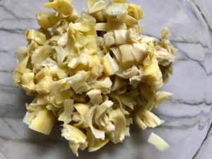 Cut artichoke hearts for Artichoke Spinach Stuffed Zucchini Recipe. Each fantastic bite gives you creamy artichoke, nutty cheesy Parmesan, spinach, and zucchini. Prepare entirely ahead, then bake 20 minutes and enjoy! #vegetarian #zucchini #stuffedzuchini #spinach #artichoke #springrecipes #healthyfood #healthydinner #healthyrecipes #glutenfree