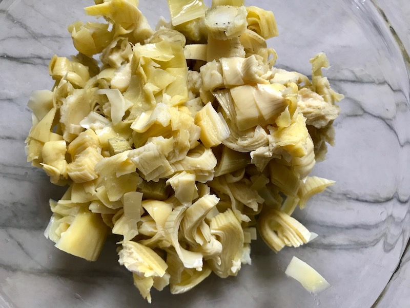 Cut artichoke hearts for Artichoke Spinach Stuffed Zucchini Recipe. Each fantastic bite gives you creamy artichoke, nutty cheesy Parmesan, spinach, and zucchini. Prepare entirely ahead, then bake 20 minutes and enjoy! #vegetarian #zucchini #stuffedzuchini #spinach #artichoke #springrecipes #healthyfood #healthydinner #healthyrecipes #glutenfree