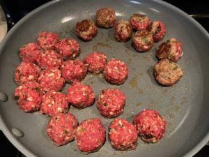 Flipping meatballs over in skillet for Meatballs in Cauliflower Dill Cream Sauce. #meatballs #swedishmeatballs #familydinner #easydinner #dinner #healthydinner