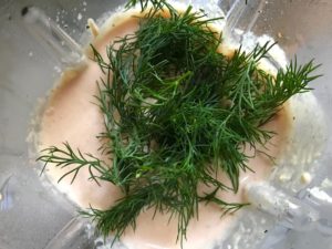 Fresh Dill added to Cauliflower cream sauce over blender for Meatballs in Cauliflower Dill Cream Sauce. #meatballs #swedishmeatballs #familydinner #easydinner #dinner #healthydinner