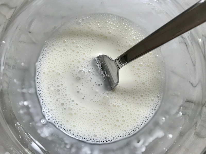 Fork mixing cornstarch into water for Lemon Dill Sauce Chicken and Asparagus. It has chicken in a light and creamy sauce flavored with garlic, lemon and fresh dill. It's loaded with fresh asparagus. #springrecipes #dinner #easydinner #healthydinner #lemon #asparagus #chicken #glutenfree #easyrecipes