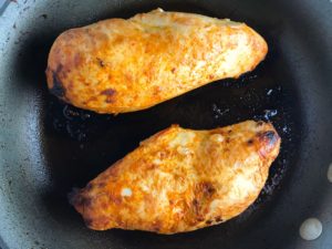 Hungarian Paprika Chicken cooking in a skillet. The paprika gives beautiful color and a deep, peppery flavor. #chicken #easychicken #easydinner #dinner #healthydinner