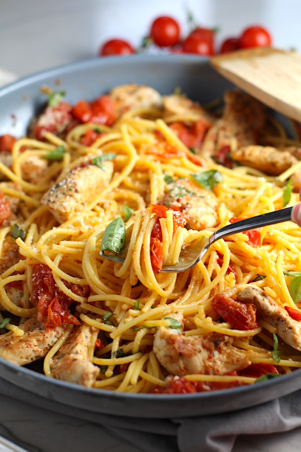 Chicken and Cherry Tomato Pasta with basil and parmesan in a skillet. It's easy and so delicious! #pasta #tomatoes #easydinner #dinner #easyrecipes #healthydinner #chicken