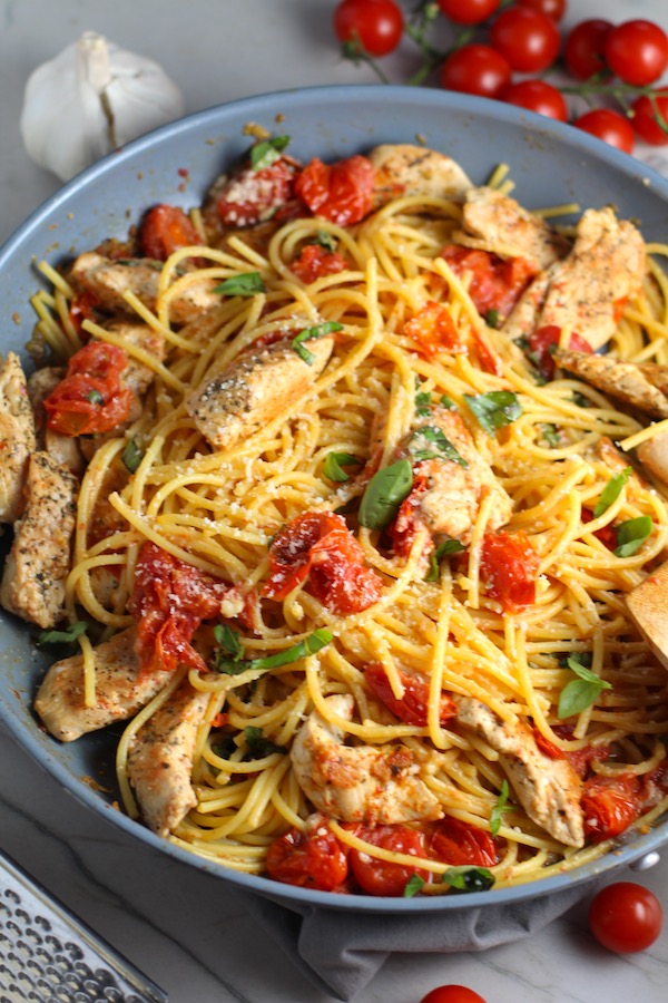Chicken and Cherry Tomato Pasta with basil and parmesan in a skillet. It's easy and so delicious! #pasta #tomatoes #easydinner #dinner #easyrecipes #healthydinner #chicken