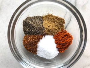 Spices in a bowl for Skillet Eggs in Spicy Tomato Pepper Sauce with Manchego Cheese. With a smoky, spicy, thick, and luscious red pepper tomato sauce. #eggs #huevosrancheros #tomatosauce #easydinner #brunch #shakshuka