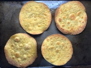 4 crispy corn tortillas on sheet pan for Skillet Eggs in Spicy Tomato Pepper Sauce with Manchego Cheese. With a smoky, spicy, thick, and luscious red pepper tomato sauce. #eggs #huevosrancheros #tomatosauce #easydinner #brunch #shakshuka