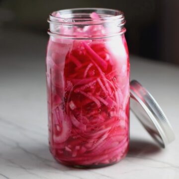 These Perfectly Pickled Onions are tart, tangy, sweet, and savory. They go on just about anything and are so unbelievably delicious, they can make a shoe taste good! Best part, you can make a ton of them ahead!