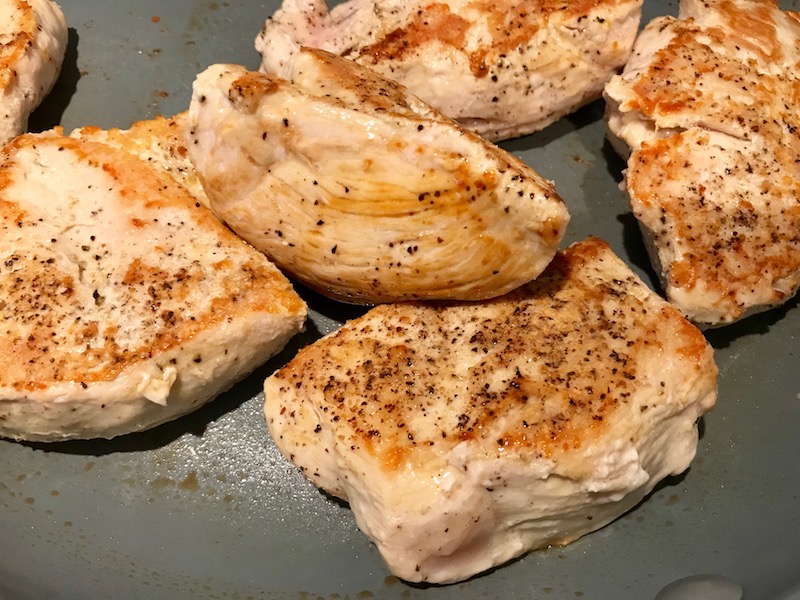 Seared chicken in skillet for Artichoke Chicken with sun dried tomatoes, basil, garlic, in cream sauce. #skilletchicken #skilletdinner #chicken #easydinner #familydinner #italian #tuscanchicken