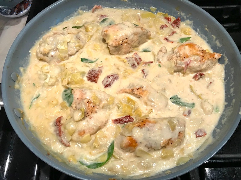 Skillet Artichoke Chicken with sun dried tomatoes, basil, garlic, in cream sauce. #skilletchicken #skilletdinner #chicken #easydinner #familydinner #italian #tuscanchicken