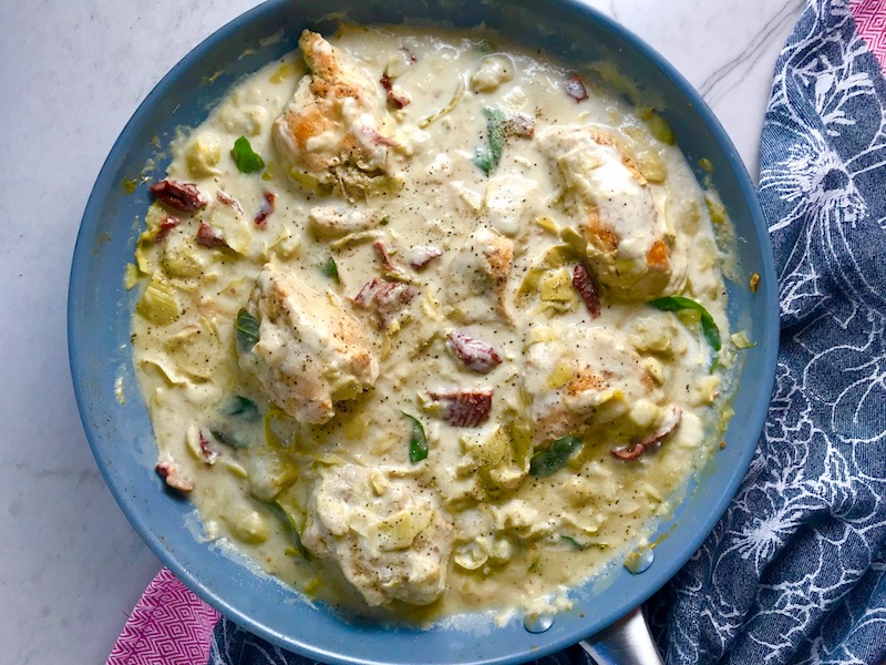 Skillet Artichoke Chicken with sun dried tomatoes, basil, garlic, in cream sauce. #skilletchicken #skilletdinner #chicken #easydinner #familydinner #italian #tuscanchicken