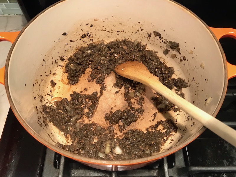 Pureed Mushrooms in pot with spoon for Thick & Creamy Healthy Mushroom Soup. The soup has earthy mushrooms, aeromatic onions, flavorful oregano, and bright chives.