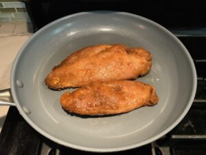 Marinated Mexican Chicken cooking in skillet. This marinade is an easy, make-ahead, and delicious recipe! The chicken is infused with so much smokey, savory flavors from the fresh garlic, chili powder, and cumin. #marinade #chicken #easydinners