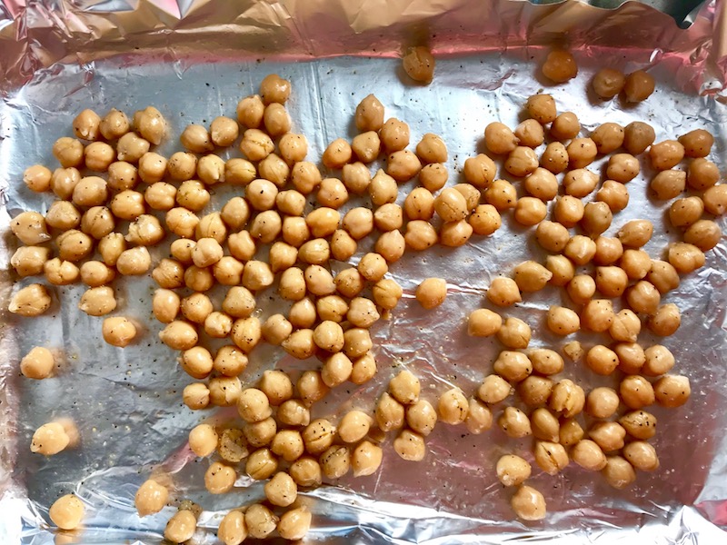 Chickpeas on pan for Family Coconut Curry. The sauce has onion, coconut milk, ginger, garlic, and warm Indian Curry spices.