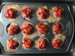 Cooked Mini Meatloaf Muffins in muffin tin. They have only 5 simple ingredients, cook in 30 minutes, and are gluten free.