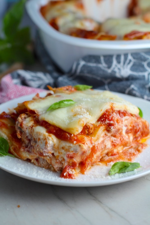 Chicken Lasagna on a plate with fresh basil. from the dish. This Italian Sausage Lasagne Recipe is the stuff that dreams are made of. Layers of pasta, creamy ricotta, salty chewy mozzarella, salty and hearty Italian Sausage, and sweet and tangy tomato sauce.