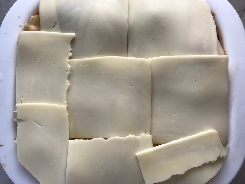 Top layer of mozzarella over uncooked lasagna for this Easy Italian Sausage Lasagne Recipe. It's the stuff that dreams are made of. Layers of pasta, creamy ricotta, salty chewy mozzarella, salty and hearty Italian Sausage, and sweet and tangy tomato sauce.