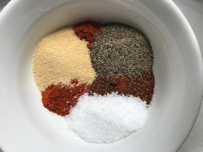 Spices separated in bowl for Smoky Pulled Beef Brisket. It's made in the Slow Cooker and is smokey, savory, tender, moist, and full of flavor. In a delicious sauce, it goes great on a sandwich, over polenta, on rice, or potatoes. #slowcooker #crockpot #brisket #beefbrisket #pulledbeef #pulledpork